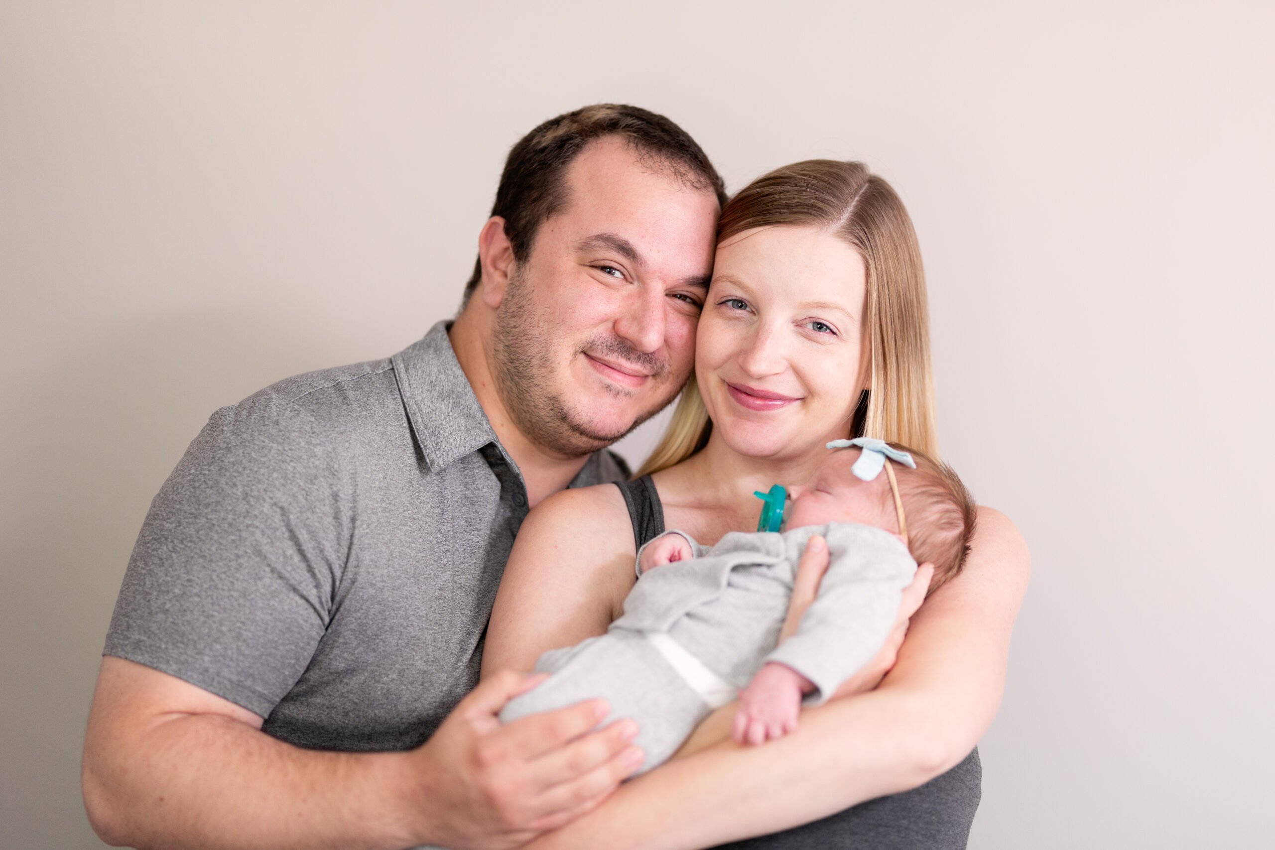 in-home lifestyle newborn session. family portrait of mom, dad, and baby